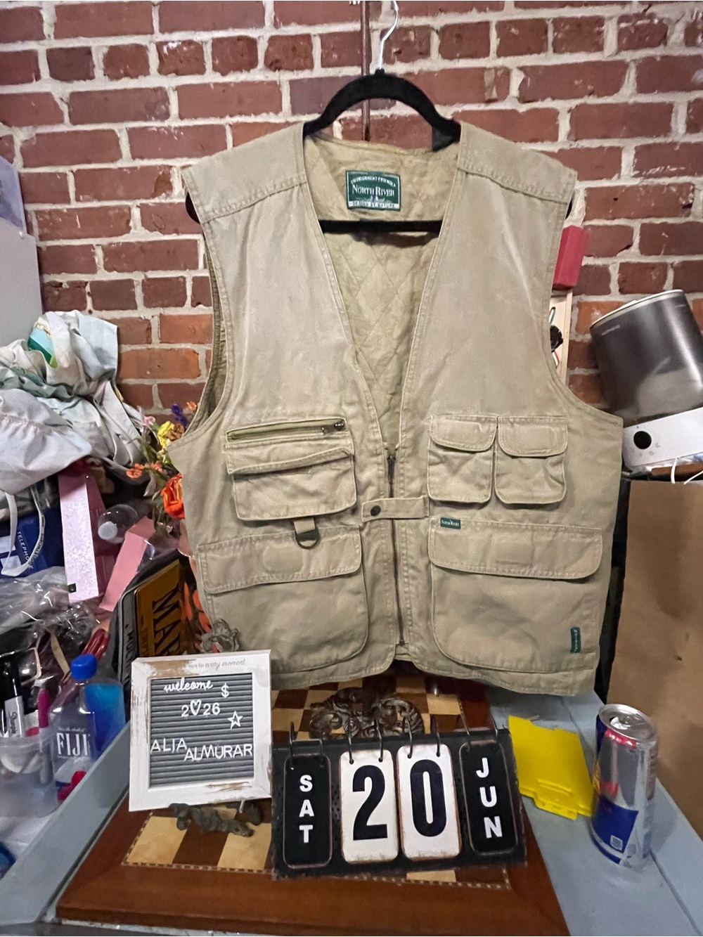 North River brand khaki fishing vest features multiple front pockets